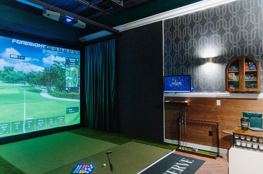 The Golf Reserve private simulator bay with lounge seating